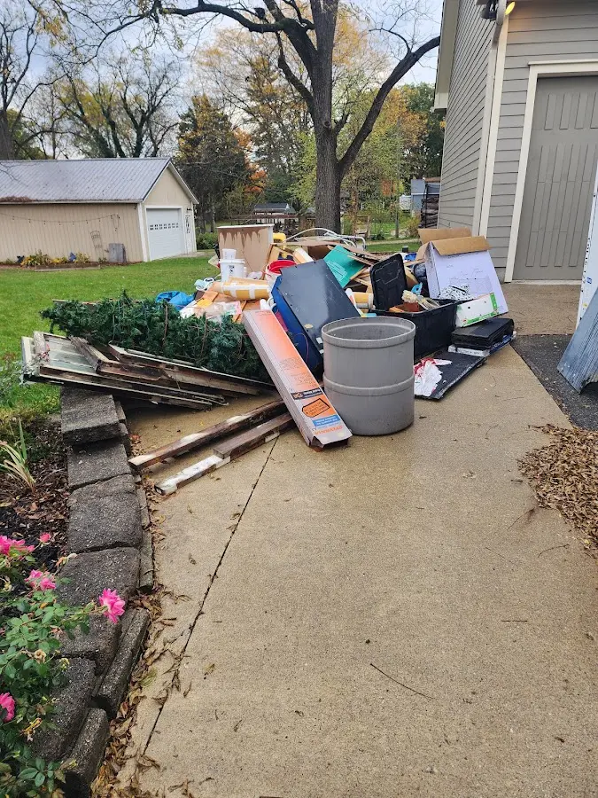 Dumpster being loaded with debris for 12 Yard Dumpster Rental in Greenwich